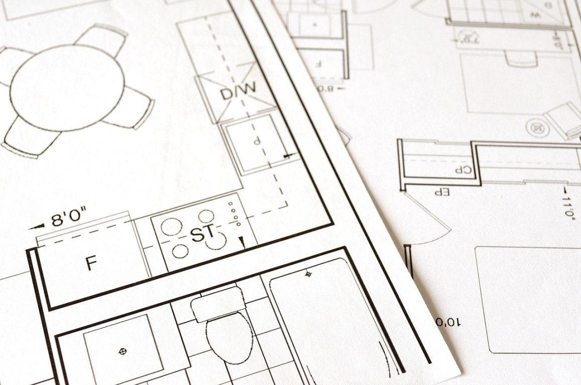 construction engineers blueprint meeting
